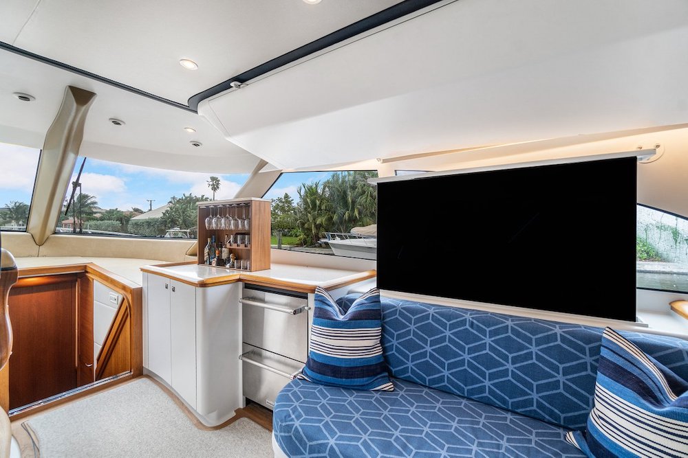 Upper Salon / Lower Helm Station with TV and Bar on the 64' F&S Custom Sportfish Express Freyja